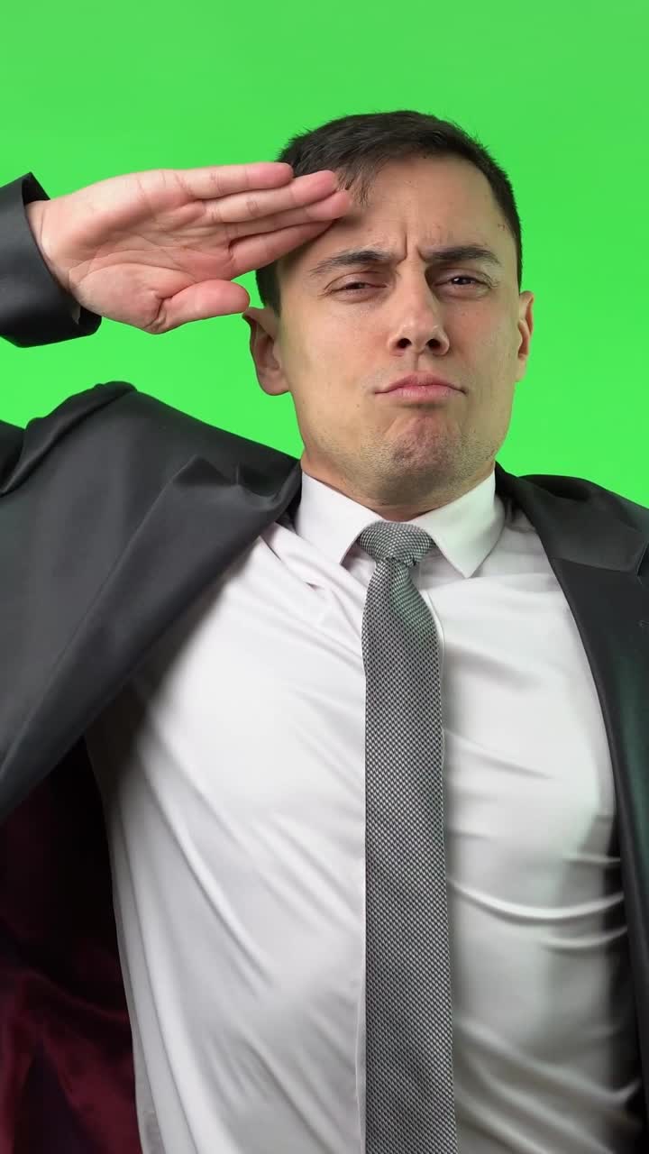 Man in Suit Saluting and Smiling on Green Screen
