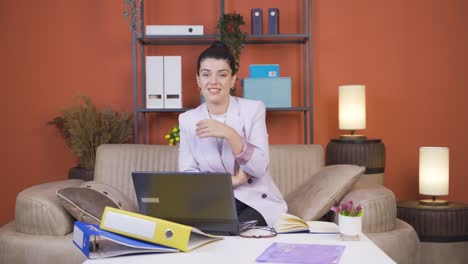 home office worker young woman looking smugly at camera.