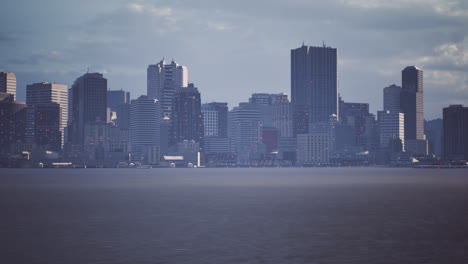 dramatic skyline view of a modern city by the waterfront during twilight