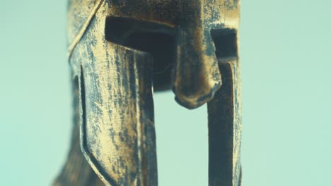 A-rotating-close-up-macro-shot-of-a-spartan-warrior-metal-bronze-ancient-greek-helmet,-studio-lighting,-slow-motion,-4K-video