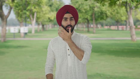 happy sikh indian man getting ready to go out in park