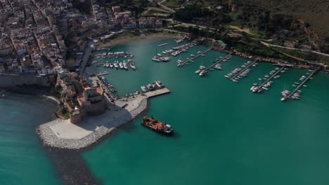 aerial view of castellammare del golfo port in sicily with castello arabo normanno on sunny day