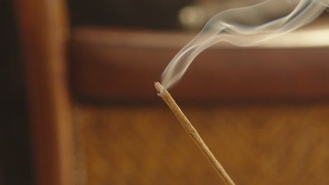 burning incense stick closeup view of spiritual fragrant smoke in focus