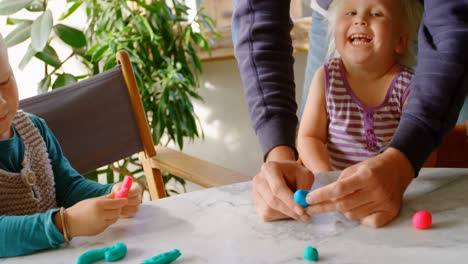 Father-and-children-playing-together-with-clay-in-a-comfortable-home-4k