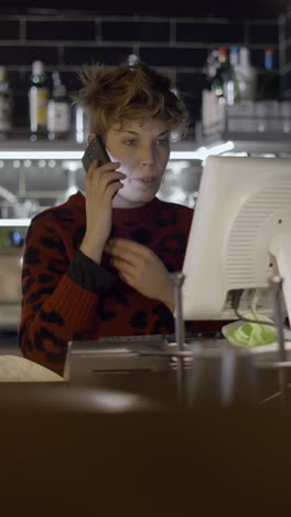 woman using smartphone at a bar counter