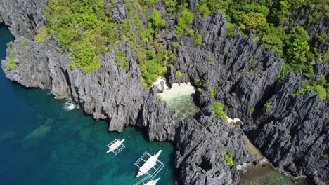 people swimming at the secret beach in el nido, philippines with island hopping tour boats against karst