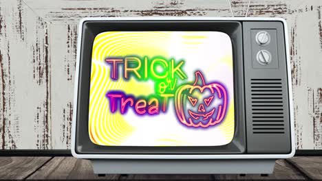 animación del texto de halloween de truco o trato en la pantalla de una televisión antigua
