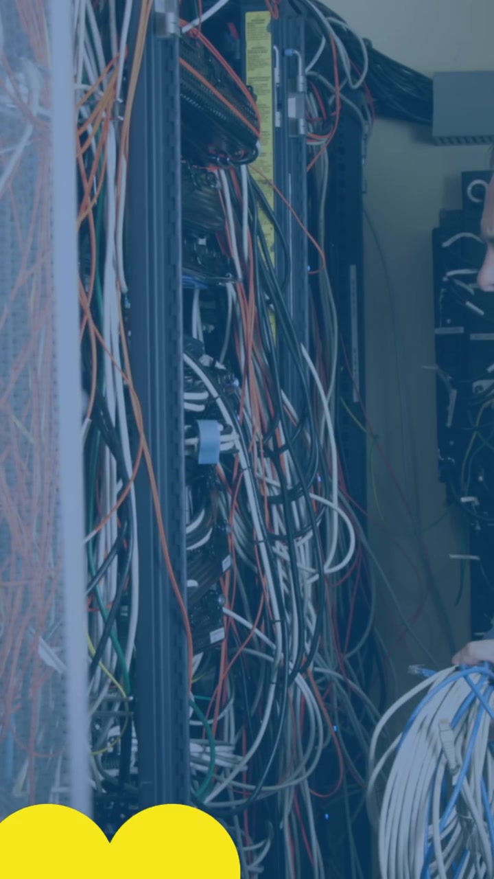 Animation of hearts over caucasian businessman in server room