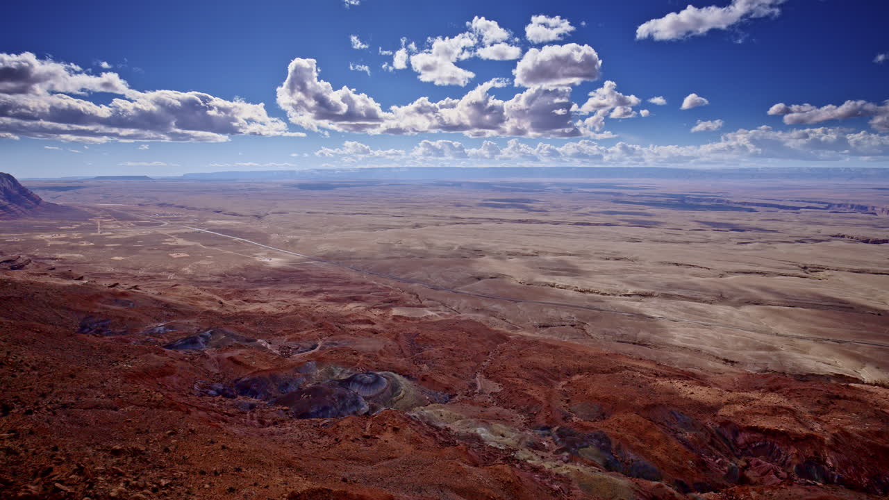 Aerial camera flying above a surreal canvas of red rock near Page, Arizona.