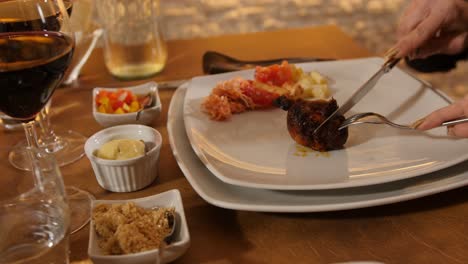 churrascaria - the hands of a girl slice a piece of chicken ad a brazilian fine restaurant