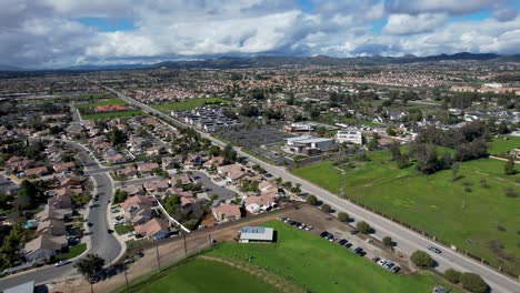 Aerial-view-of-Murrieta,-California:-lush-green-grass,-blue-skies,-and-suburban-homes-create-a-picturesque-scene-of-tranquility-and-suburban-charm