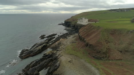 Aerial-view-moving-across-the-headland-heading-from-Dunbeath-towards-Dunbeath-Castle,-Caithness,-Scotland