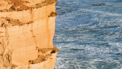 ocean waves hitting the twelve apostles cliffs