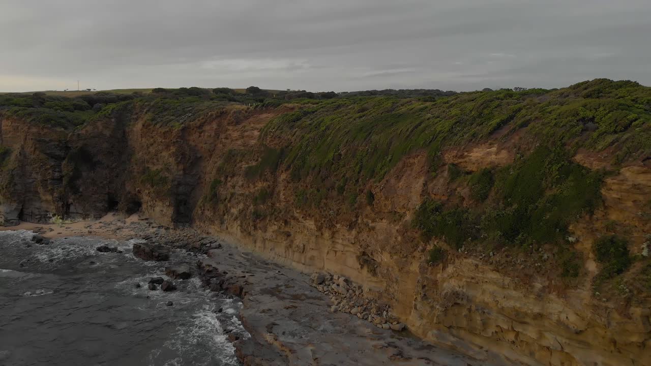 Aerial shot of cliffs on Bass coast with cars parked on top