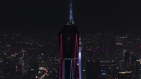 telezoom aerial orbiting the merdeka 118 tower, night in kuala lumpur, malaysia