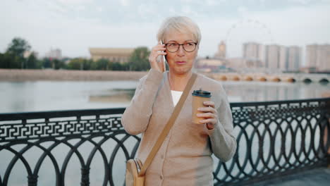 senior woman talking on phone and enjoying coffee