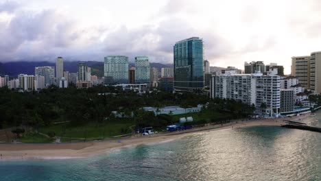 Drone-shot-of-Honolulu's-shoreline-with-hotels-and-skyscrapers-in-the-distance