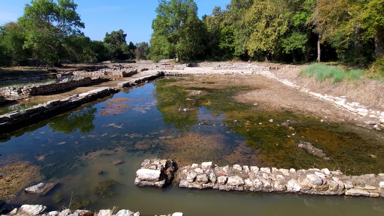 Sunken City: Stone Walls of an Ancient City Gracefully Submerged in Lagoon Waters Within Butrint's Archaeological Site