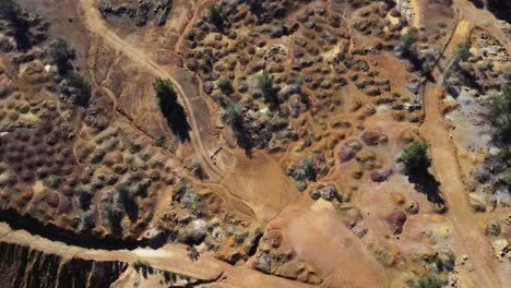 aerial view of the colored rocks and terrain beside red lake in cyprus, greece near the mitsero mines