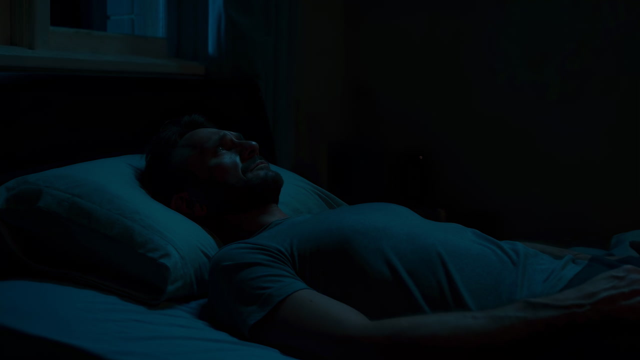 Man Lying Awake In Dark Bedroom, Freelancer Struggling With Insomnia And Latenight Anxiety, Moonlight
