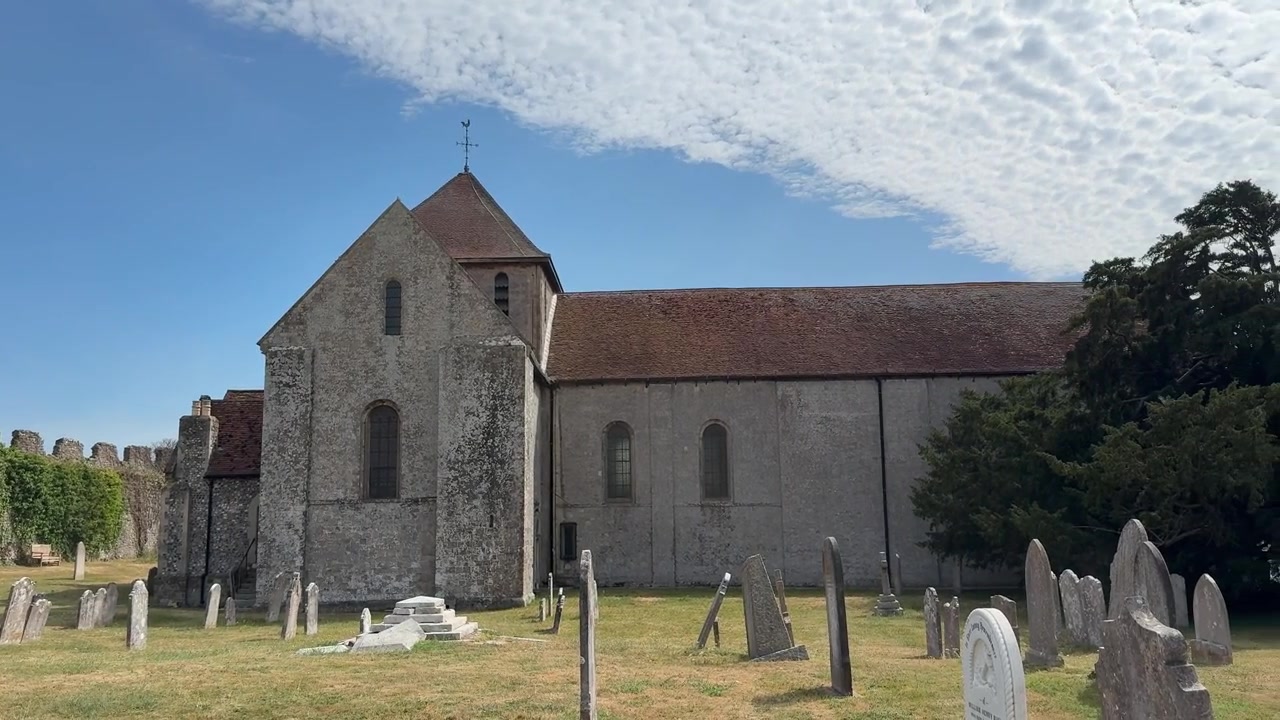 Panning shot of St Mary's Church and its historic graveyard in Fareham, England