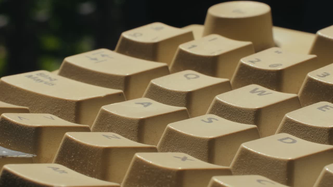 Man working and gaming on retro computer PC, IT engineer with vintage computer at home, using old fashion technology, close up of retro setup.