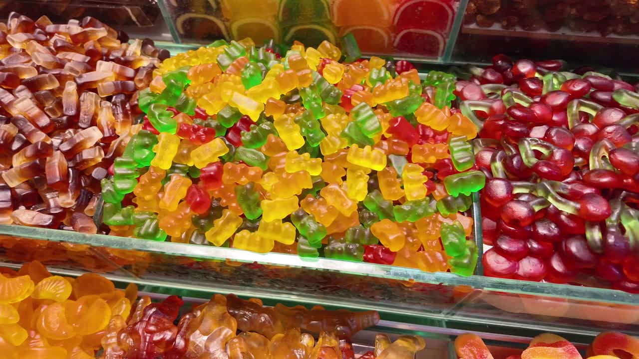A vibrant display of assorted gummy candies including bears and cherries