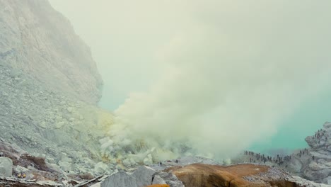 toxic sulfuric gases rising from the sulfur mine inside crater of ijen volcano