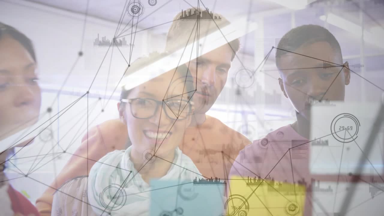 Upon digital overlay appearing, team examining glass board adding notes, refining business strategy