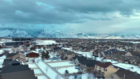 snow day in the suburbs below the mountains - aerial flyover