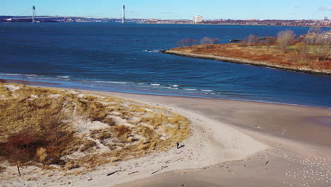 an aerial drone shot over a man walking on a beach