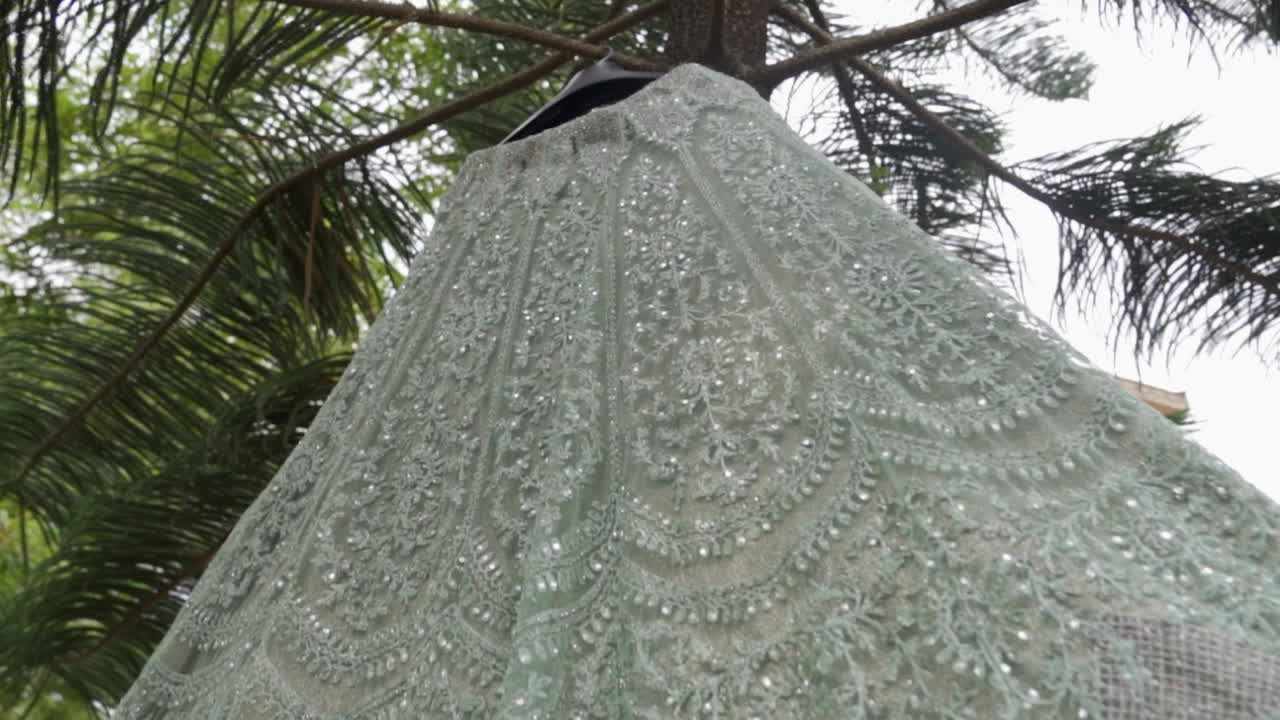 An elegant bridal gown draped outdoors, perfect for reception themes, slow-motion vibe