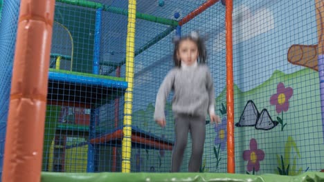 girl jump on trampolines in the children's entertainment center. trampoline entertaining game center. playroom