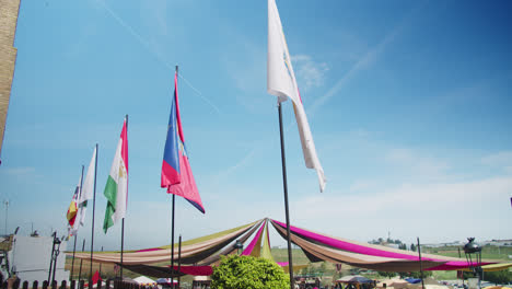 Beautiful-shot-of-different-flags-of-medieval-towns-at-a-medieval-festival-in-Huelva,-Spain