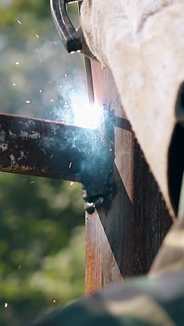 welding metal pipe outdoors