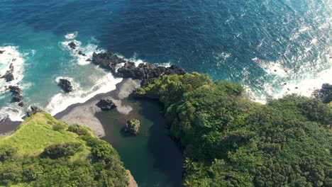 aerial orbiting shot over scenic waioka pond by the pacific ocean, maui