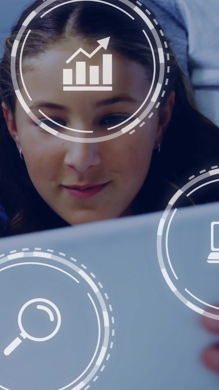 Vertical video: Preteen girl scanning tablet while HUD icons overlaying face for school