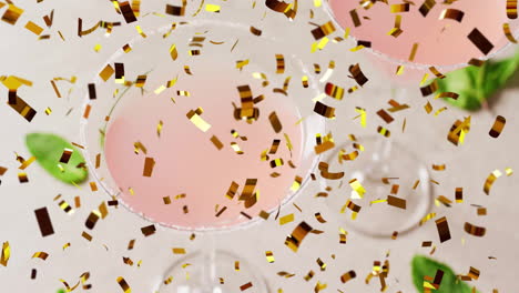 Animation-of-confetti-falling-and-cocktails-on-white-background