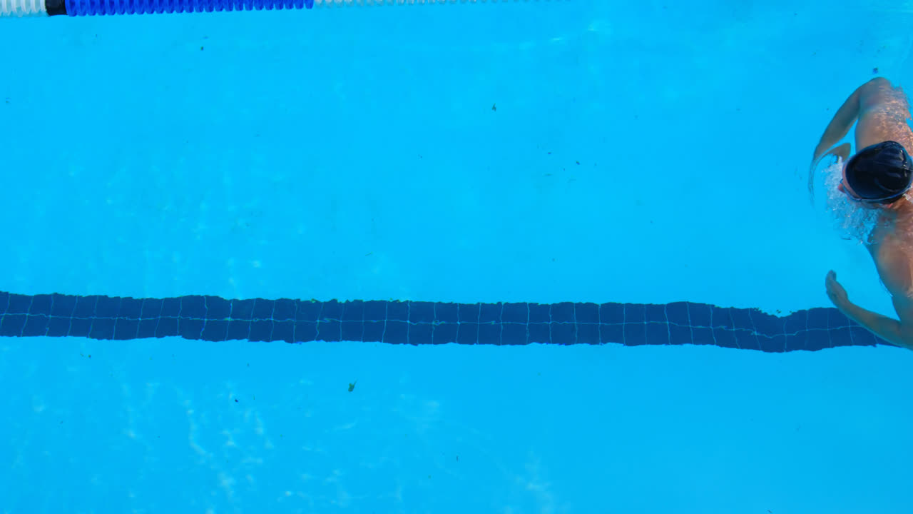 High angle view of male swimmer swimming inside pool 4k