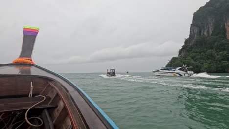 longtail boat and speedboat on the water