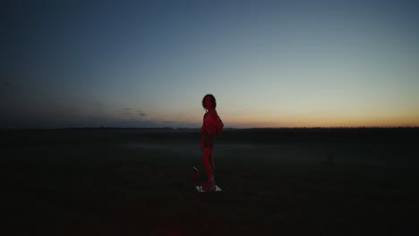 woman in field at sunset