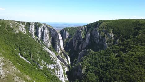 el dron volando hacia atrás revela la increíble vista de la parte superior del desfiladero de turda y el paisaje más allá en el horizonte