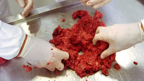 Hands-of-butchers-preparing-meat-ball-from-minced-meat