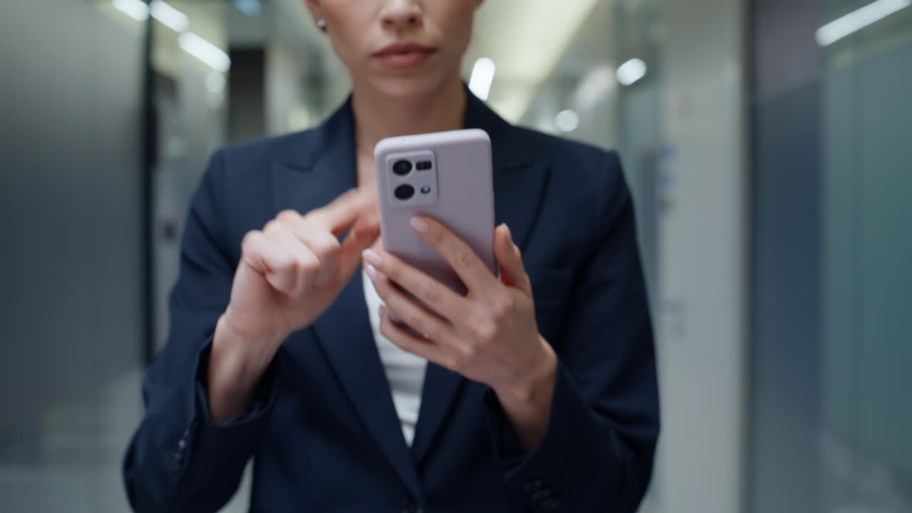 Businesswoman finger touching mobile phone walking corporate agency hall closeup