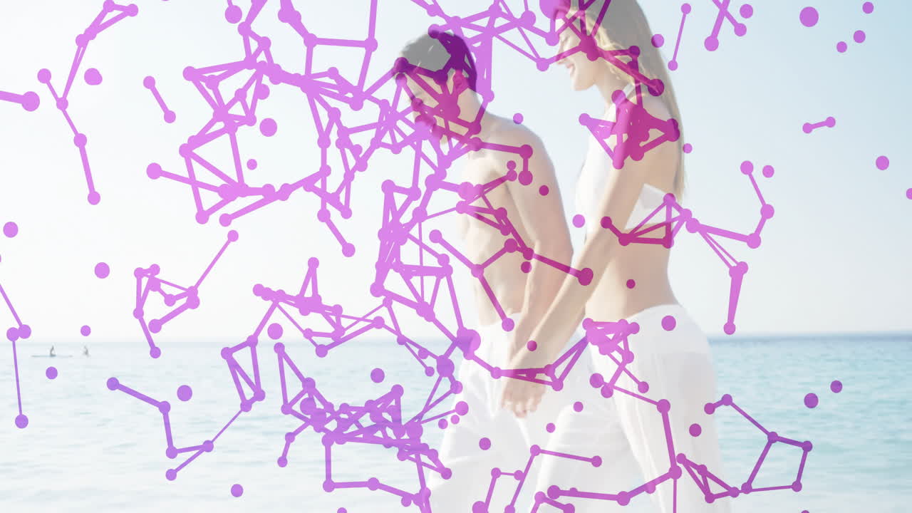 Walking on beach, couple with purple network animation overlay, enjoying scenery