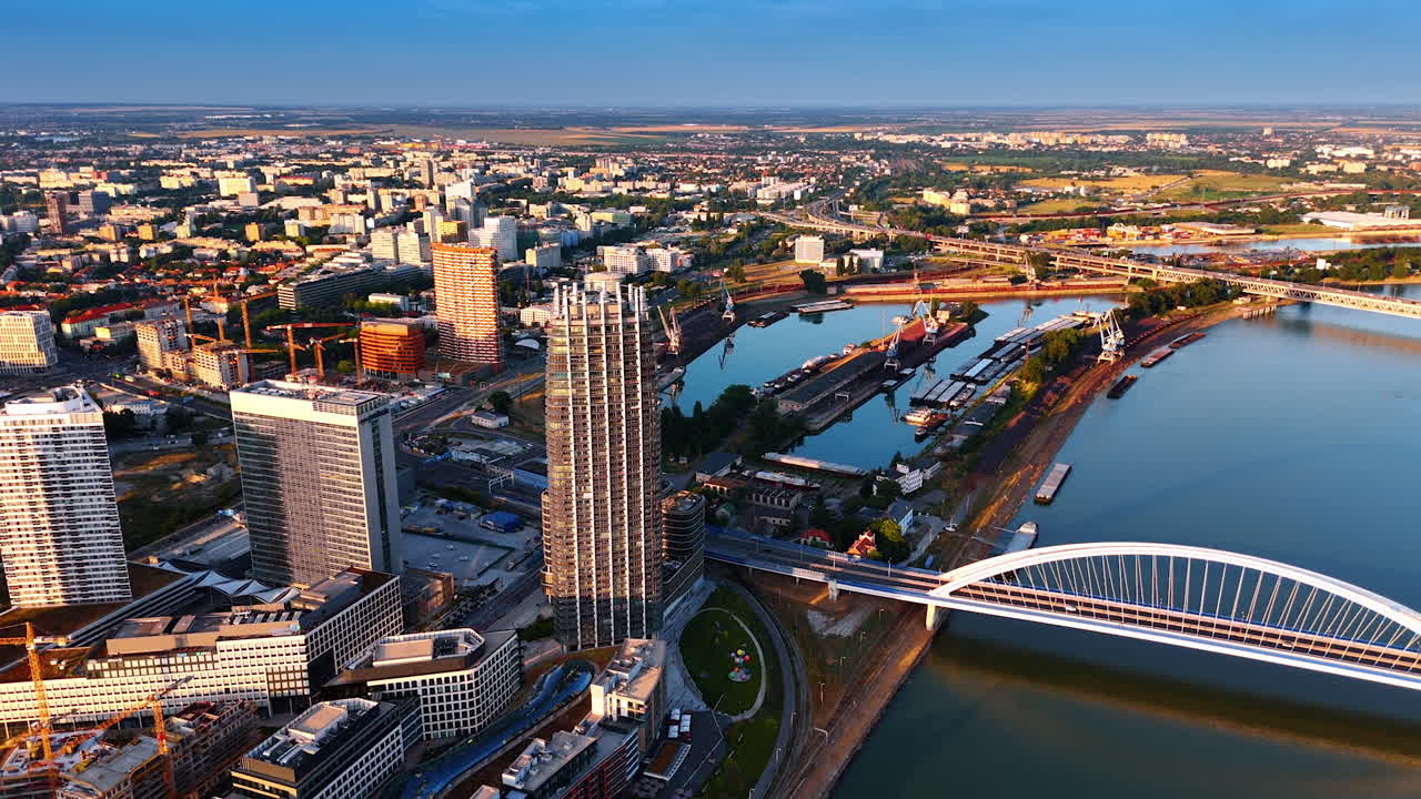 Modern cityscape of Bratislava, Slovakia. Drone footage descending above the Danube River close to the Appolo Bridge