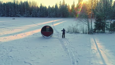 Drone-shot-following-a-cross-country-skier-leaving-home-on-their-daily-commute