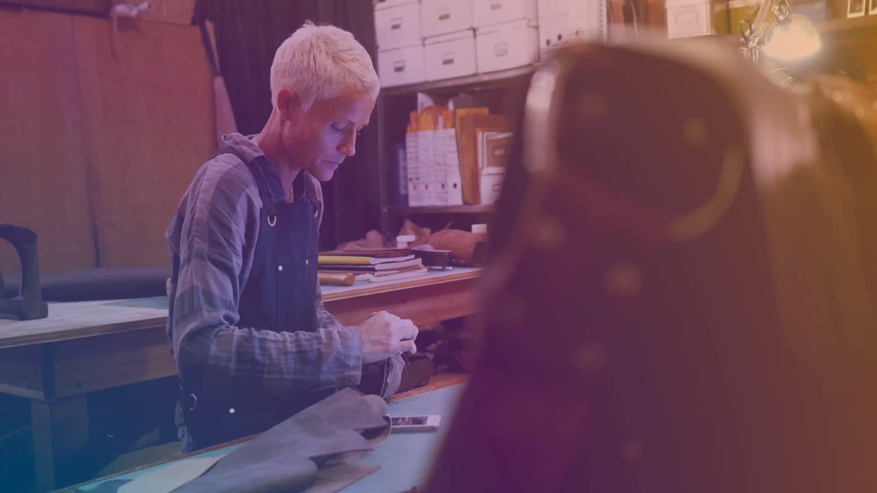 Animation of caucasian female worker repairing smartphone in workshop