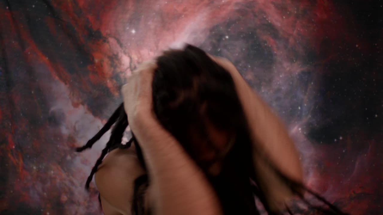 Afro-Spanish man wrestling with inner voices. Cosmic nebula backdrop