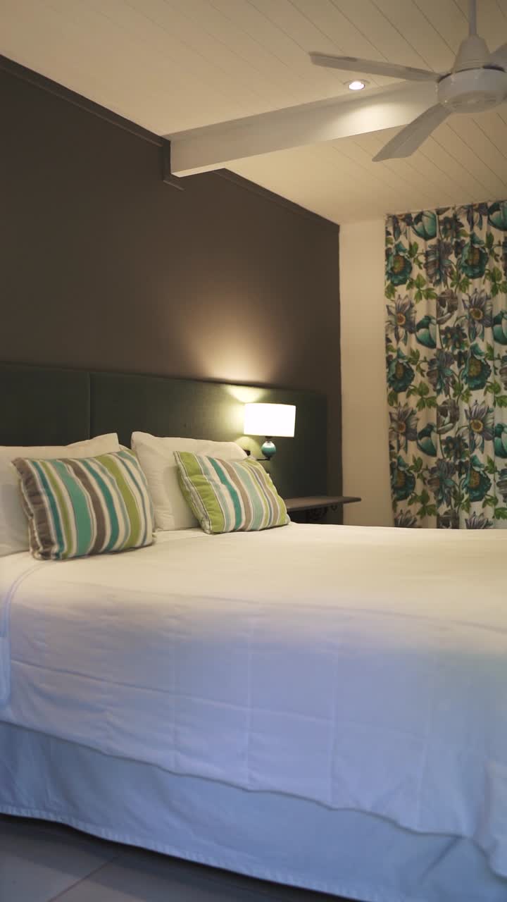 Modern bedroom interior with a comfortable bed and decorative curtain patterns, Patagonia, Argentina.